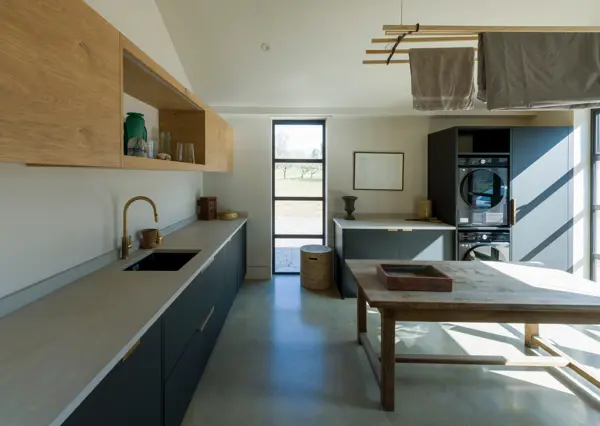 Beyond the kitchen, it’s the hardworking spaces that shine. A utility room come boot-room built to blend purpose with design.