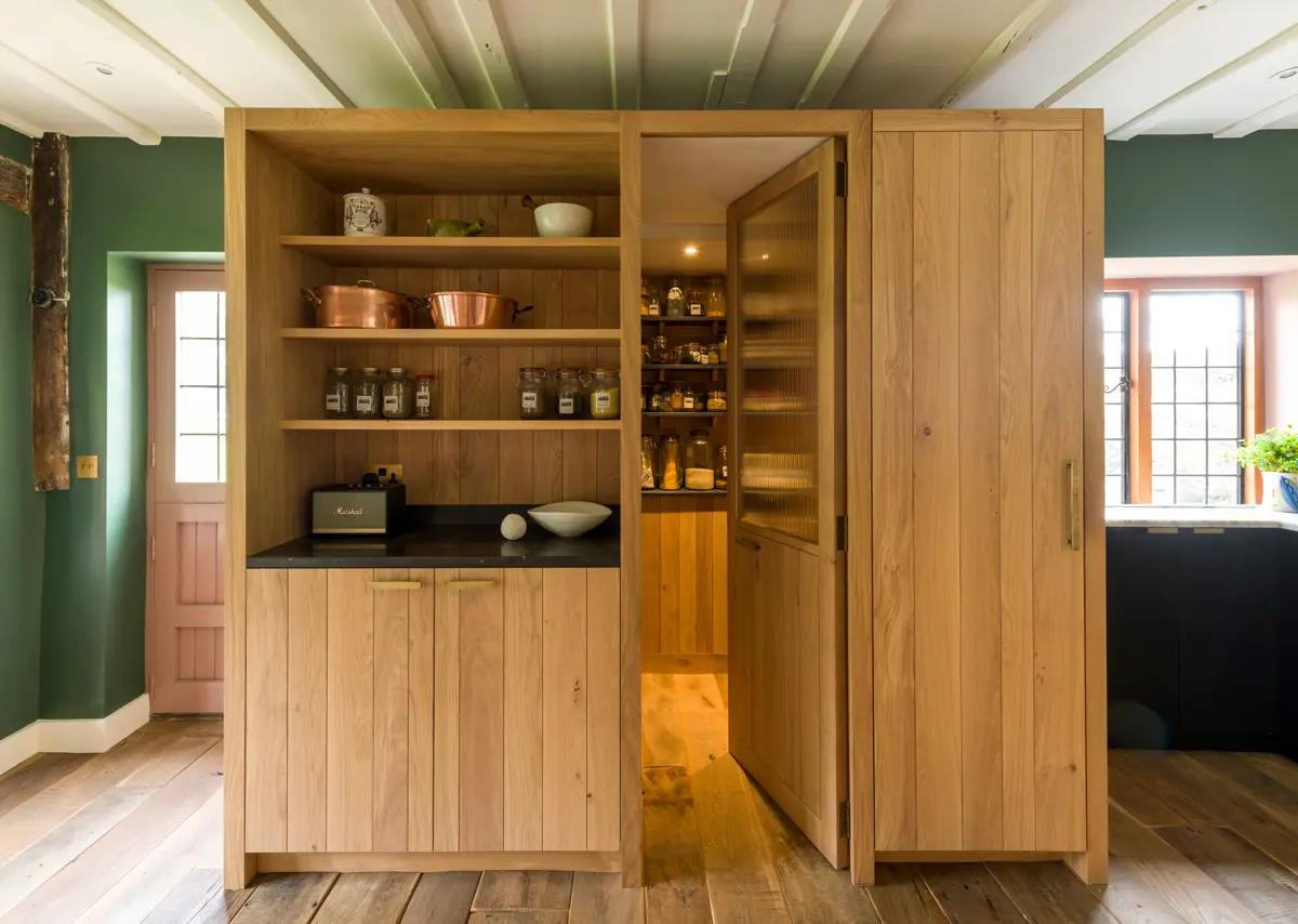 Transformative design creates a unique walk in pantry space of unparalleled elegance within an inglenook chimney. Considered design for modern living.